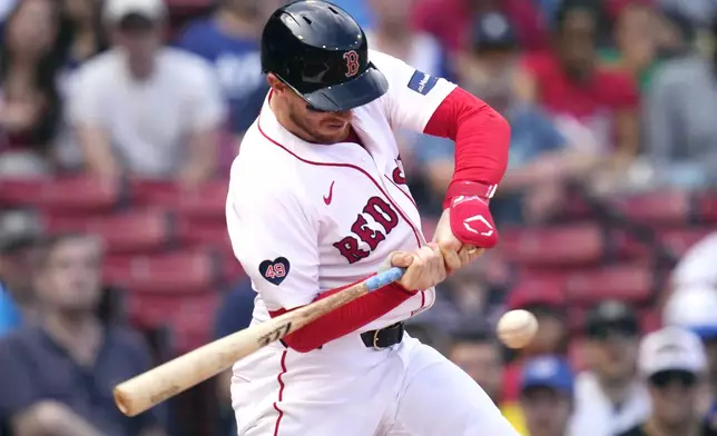 Boston Red Sox catcher Danny Jansen lines out during the resumption of the second inning of a baseball game against the Toronto Blue Jays, which was delayed due to rain in June, against the Toronto Blue Jays at Fenway Park, Monday, Aug. 26, 2024, in Boston. (AP Photo/Charles Krupa)