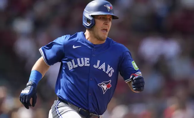 Toronto Blue Jays' Daulton Varsho dashes down the first base line on his single during the fifth inning of a baseball game against the Boston Red Sox at Fenway Park, Monday, Aug. 26, 2024, in Boston. (AP Photo/Charles Krupa)