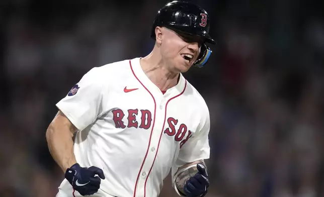 Boston Red Sox's Tyler O'Neill celebrates while rounding the bases on his two-run home run in the eighth inning of a baseball game against the Toronto Blue Jays at Fenway Park, Wednesday, Aug. 28, 2024, in Boston. (AP Photo/Charles Krupa)