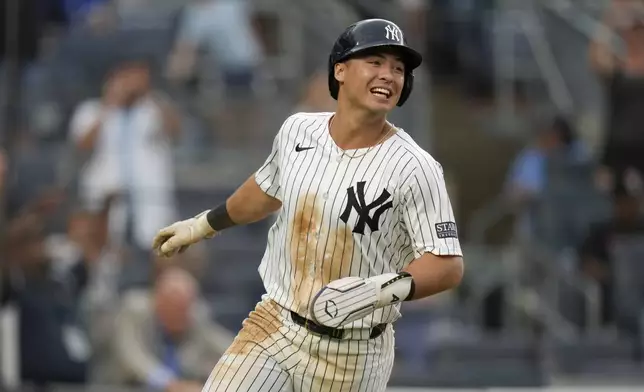 New York Yankees' Anthony Volpe reacts as he scores on a single hit by DJ LeMahieu during the 10th inning of a baseball game against the Toronto Blue Jays at Yankee Stadium, Sunday, Aug. 4, 2024, in New York. (AP Photo/Seth Wenig)