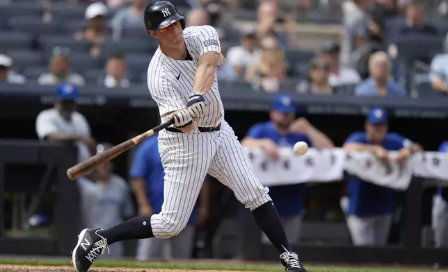 New York Yankees' DJ LeMahieu hits a sacrifice fly during the sixth inning of a baseball game against the Toronto Blue Jays at Yankee Stadium, Sunday, Aug. 4, 2024, in New York. (AP Photo/Seth Wenig)