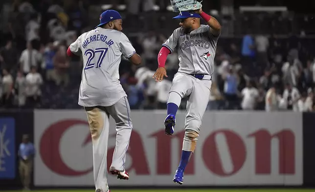 Toronto Blue Jays' Vladimir Guerrero Jr., left, and Steward Berroa, right, react after winning a baseball game against the New York Yankees, Friday, Aug. 2, 2024, in New York. (AP Photo/Pamela Smith)