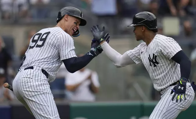 New York Yankees' Juan Soto, right, celebrates after his solo home run with Aaron Judge, left, during the seventh inning of a baseball game against the Toronto Blue Jays at Yankee Stadium, Sunday, Aug. 4, 2024, in New York. (AP Photo/Seth Wenig)