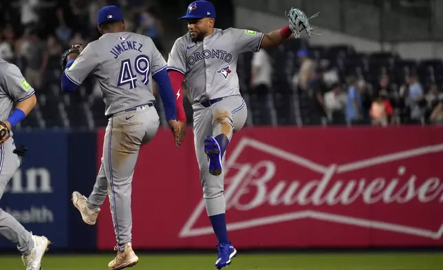 Toronto Blue Jays' Leo Jiménez, left, and Steward Berroa, right, celebrate after winning a baseball game against the New York Yankees, Friday, Aug. 2, 2024, in New York. (AP Photo/Pamela Smith)