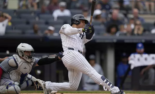 New York Yankees' Juan Soto, right, hits a solo home run during the seventh inning of a baseball game against the Toronto Blue Jays at Yankee Stadium, Sunday, Aug. 4, 2024, in New York. (AP Photo/Seth Wenig)