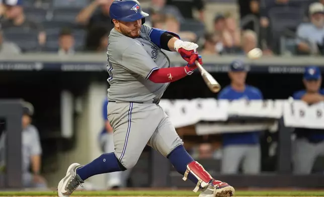 Toronto Blue Jays' Alejandro Kirk hits a sacrifice fly during the eighth inning of a baseball game against the New York Yankees at Yankee Stadium, Sunday, Aug. 4, 2024, in New York. (AP Photo/Seth Wenig)