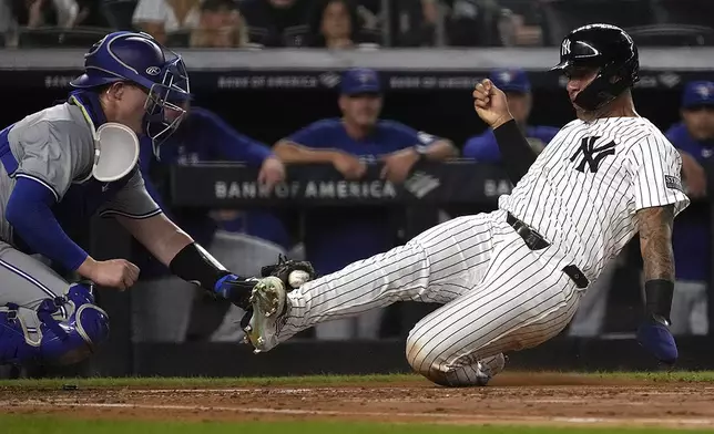 New York Yankees' Gleyber Torres, right, is tagged out at home plate by Toronto Blue Jays catcher Brian Serven, left, during the second inning of a baseball game, Friday, Aug. 2, 2024, in New York. (AP Photo/Pamela Smith)