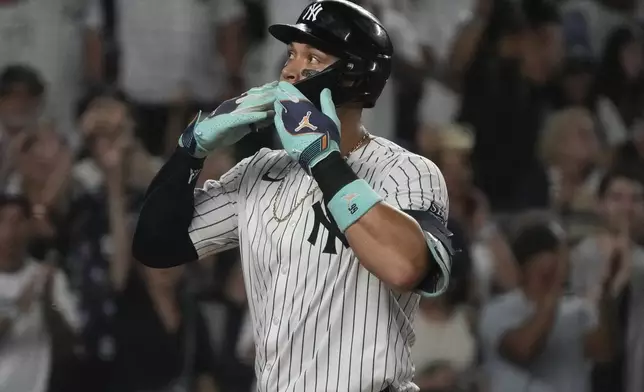 New York Yankees' Aaron Judge celebrates hitting a home run to score Juan Soto during the first inning of a baseball game against the Toronto Blue Jays, Friday, Aug. 2, 2024, in New York. (AP Photo/Pamela Smith)