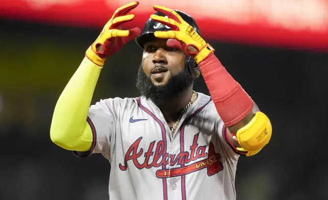 Atlanta Braves designated hitter Marcell Ozuna gestures after hitting a single during the seventh inning of a baseball game against the Los Angeles Angels, Saturday, Aug. 17, 2024, in Anaheim, Calif. (AP Photo/Ryan Sun)