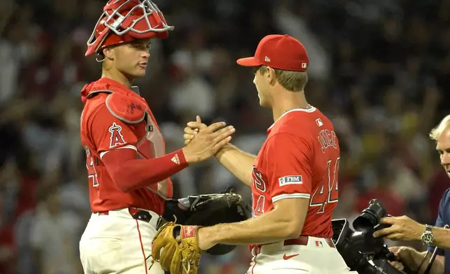 Los Angeles Angels' Logan O'Hoppe, left, congratulates Ben Joyce (44) after a save in the ninth inning against the Atlanta Braves during a baseball game Friday, Aug. 16, 2024, in Anaheim, Calif. (AP Photo/Jayne Kamin-Oncea)