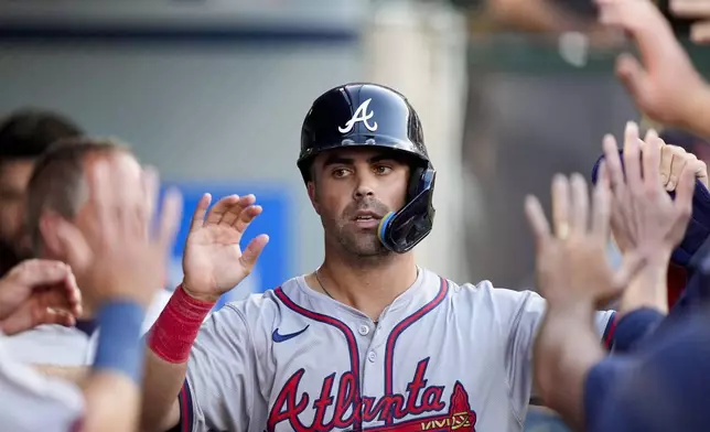 Atlanta Braves' Whitt Merrifield celebrates after scoring off a single hit by Michael Harris II during the second inning of a baseball game against the Los Angeles Angels, Saturday, Aug. 17, 2024, in Anaheim, Calif. (AP Photo/Ryan Sun)