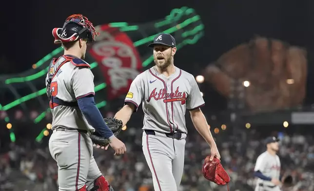 Atlanta Braves catcher Sean Murphy, left, walks off the mound with pitcher Chris Sale after San Francisco Giants' Marco Luciano popped out in foul territory during the seventh inning of a baseball game in San Francisco, Monday, Aug. 12, 2024. (AP Photo/Jeff Chiu)