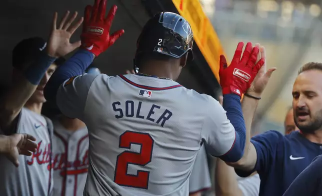 Atlanta Braves' Jorge Soler celebrates his solo home run against the Minnesota Twins in the first inning of a baseball game Wednesday, Aug. 28, 2024, in Minneapolis. (AP Photo/Bruce Kluckhohn)