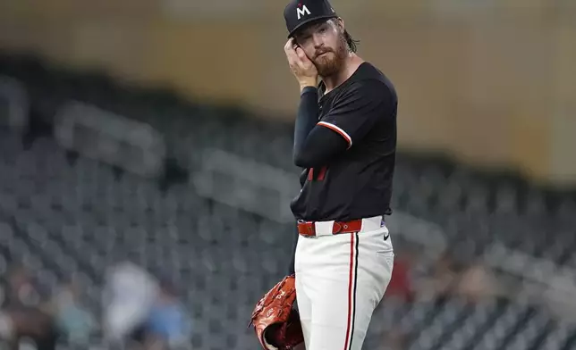 Minnesota Twins starting pitcher Bailey Ober reacts after a two-run home run by Atlanta Braves' Travis d'Arnaud during the second inning of a baseball game Monday, Aug. 26, 2024, in Minneapolis. (AP Photo/Abbie Parr)