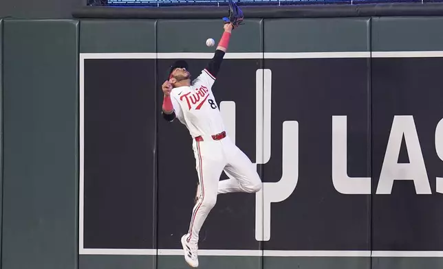 Minnesota Twins center fielder Austin Martin (82) fails to catch a double hit by Atlanta Braves designated hitter Marcell Ozuna during the 10th inning of a baseball game Tuesday, Aug. 27, 2024, in Minneapolis. (AP Photo/Abbie Parr)