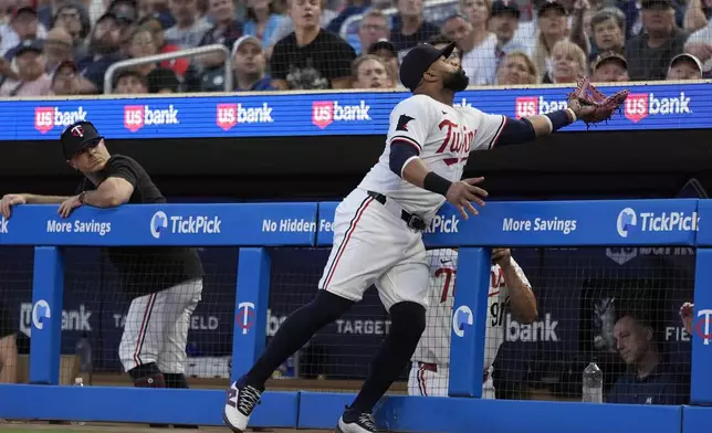 Minnesota Twins first baseman Carlos Santana catches a foul out by Atlanta Braves' Matt Olson during the fourth inning of a baseball game, Tuesday, Aug. 27, 2024, in Minneapolis. (AP Photo/Abbie Parr)