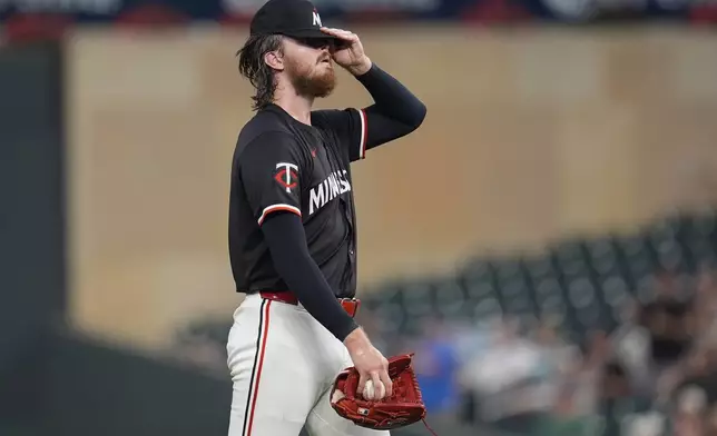 Minnesota Twins starting pitcher Bailey Ober reacts after a three-run home run by Atlanta Braves' Matt Olson during the first inning of a baseball game Monday, Aug. 26, 2024, in Minneapolis. (AP Photo/Abbie Parr)