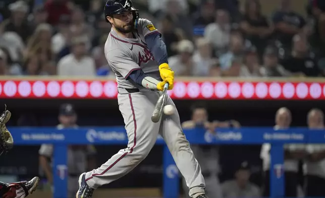 Atlanta Braves' Travis d'Arnaud hits an RBI-single during the 10th inning of a baseball game against the Minnesota Twins, Tuesday, Aug. 27, 2024, in Minneapolis. (AP Photo/Abbie Parr)