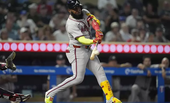 Atlanta Braves designated hitter Marcell Ozuna hits a double during the 10th inning of a baseball game against the Minnesota Twins, Tuesday, Aug. 27, 2024, in Minneapolis. (AP Photo/Abbie Parr)