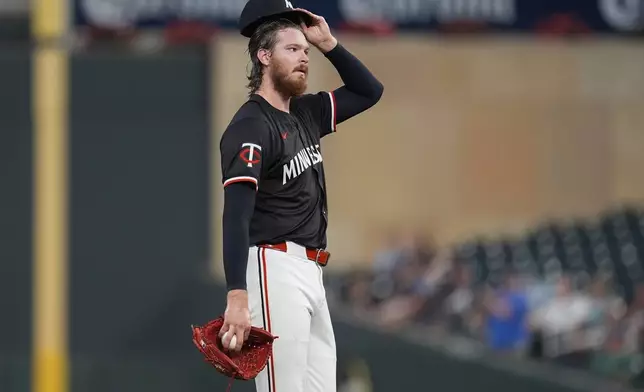 Minnesota Twins starting pitcher Bailey Ober reacts after a three-run home run by Atlanta Braves' Matt Olson during the first inning of a baseball game Monday, Aug. 26, 2024, in Minneapolis. (AP Photo/Abbie Parr)