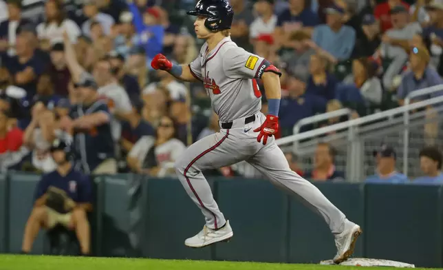 Atlanta Braves' Luke Williams rounds first base on his way to a two-run double against the Minnesota Twins in the seventh inning of a baseball game Wednesday, Aug. 28, 2024, in Minneapolis. (AP Photo/Bruce Kluckhohn)