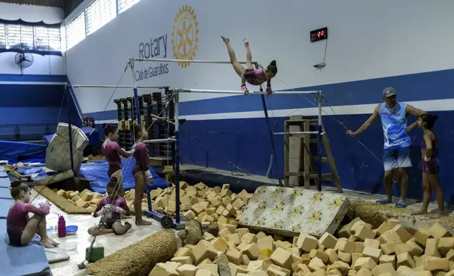 Gymnasts train at Bonifacio Cardoso gymnasium, where Olympic medalist Rebeca Andrade trained as a child in her hometown of Guarulhos, Sao Paulo, Brazil, Tuesday, Aug. 6, 2024. (AP Photo/Tuane Fernandes)