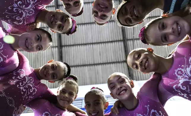 Gymnasts pose for a photo at Bonifacio Cardoso gymnasium, where Olympic medalist Rebeca Andrade trained as a child in her hometown of Guarulhos, Sao Paulo, Brazil, Tuesday, Aug. 6, 2024. (AP Photo/Tuane Fernandes)