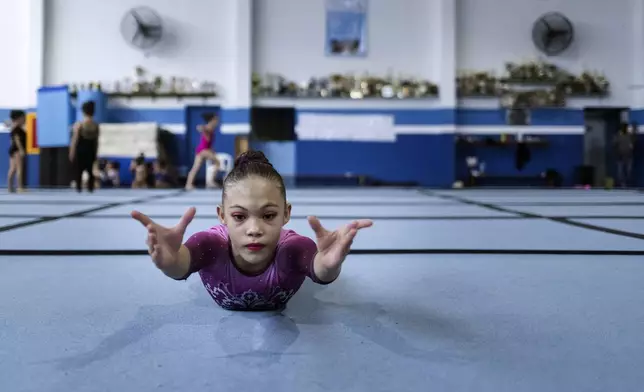 A young gymnast trains at Bonifacio Cardoso gymnasium, where Olympic medalist Rebeca Andrade trained as a child in her hometown of Guarulhos, Sao Paulo, Brazil, Tuesday, Aug. 6, 2024. (AP Photo/Tuane Fernandes)