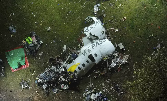 The debris at the site where an airplane crashed with 61 people on board, in Vinhedo, Sao Paulo state, Brazil, early on Saturday, Aug. 10, 2024. Brazilian authorities are working to piece together what exactly caused the plane crash in Sao Paulo state the previous day, killing all 61 people aboard. (AP Photo/Andre Penner)