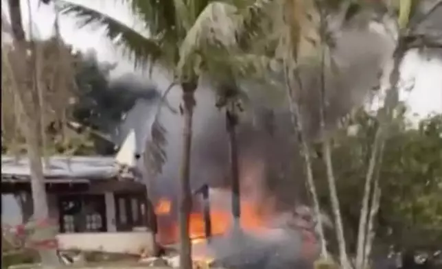 This frame grab from UGC video provided by Felipe Magalhaes Filho shows fire coming from a plane that crashed by a home in Vinhedo, Sao Paulo state, Brazil, Friday, Aug. 9, 2024. (Felipe Magalhaes Filho via AP)