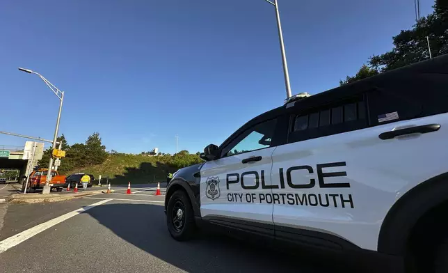 Police block a ramp to Interstate 95 and the Piscataqua River Bridge in Portsmouth, N.H., after a man connected to a homicide was fatally shot by police, and an 8-year-old child was found shot to death in the man’s car, on the bridge that connects New Hampshire to Maine, Thursday, Aug. 29, 2024. (AP Photo/Caleb Jones)