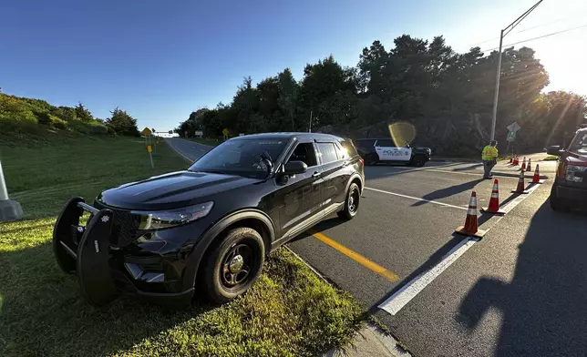 Police block a ramp to Interstate 95 and the Piscataqua River Bridge in Portsmouth, N.H. after a man connected to a homicide was fatally shot by police and an 8-year-old child was found shot to death in the man’s car on the bridge that connects New Hampshire to Maine, Thursday, Aug. 29, 2024. (AP Photo/Caleb Jones)