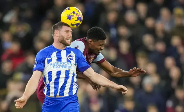 FILE - Brighton's James Milner, front, duels for the ball with West Ham's Ben Johnson during the English Premier League soccer match between West Ham and Brighton, at the London stadium in London, Tuesday, Jan. 2, 2024. (AP Photo/Kirsty Wigglesworth, File)