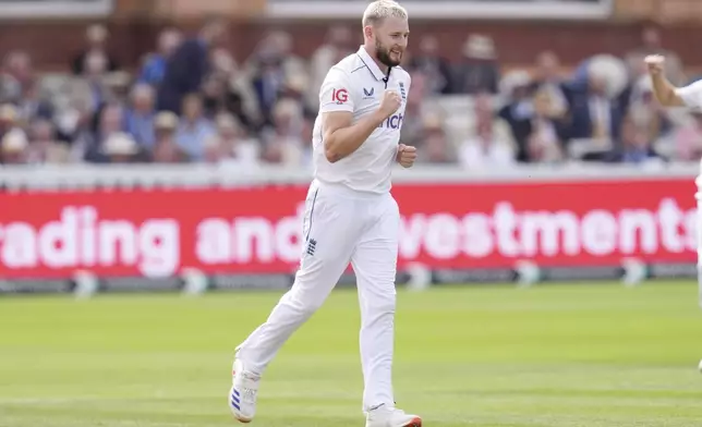 England's Gus Atkinson celebrates taking the wicket of Sri Lanka's Dinesh Chandimal during day two of the second Rothesay Men's Test cricket match between England and Sri Lanka at Lord's, London, Friday, Aug. 30, 2024. (John Walton/PA via AP)