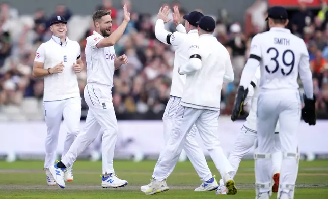 England's Chris Woakes, second left, celebrates the wicket of Sri Lanka's Nishan Madushka, not pictured, during day three of the First Test match between England and Sri Lanka at Emirates Old Trafford, Manchester, England, Thursday Aug. 22, 2024. (Nick Potts/PA via AP)