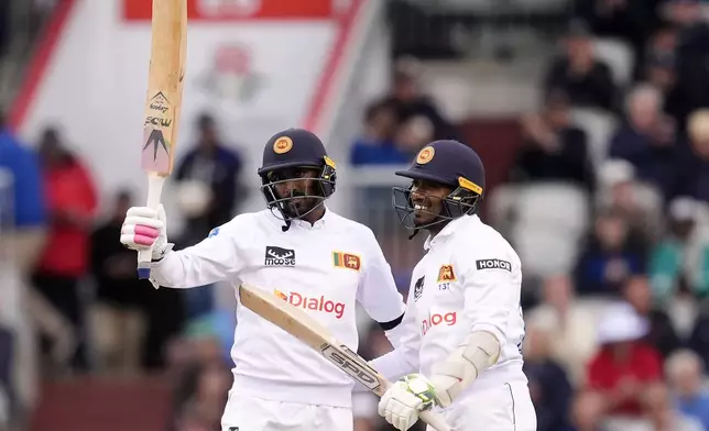 Sri Lanka's Milan Rathnayake celebrates reaching his half century on day one of the First Test match between England and Sri Lanka at Emirates Old Trafford, Manchester, England, Wednesday Aug. 21, 2024. (Nick Potts/PA via AP)