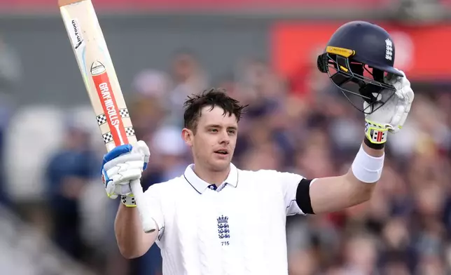 England's Jamie Smith celebrates after reaching 100 runs and his first Test hundred during day three of the First Test match between England and Sri Lanka at Emirates Old Trafford, Manchester, England, Thursday Aug. 22, 2024. (Nick Potts/PA via AP)