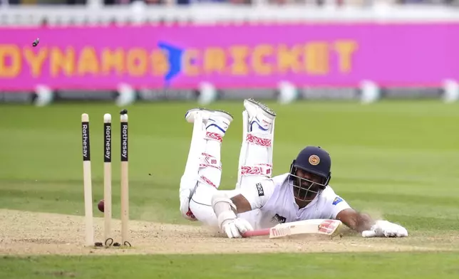 Sri Lanka's Lahiru Kumara is run out by England's Olly Pope, not shown, during day two of the second Rothesay Men's Test cricket match between England and Sri Lanka at Lord's, London, Friday, Aug. 30, 2024. (John Walton/PA via AP)