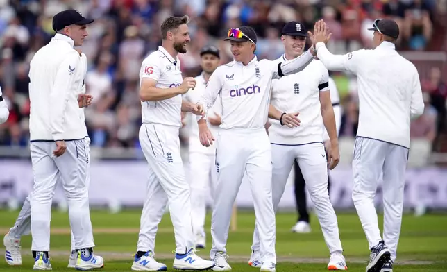 England's Chris Woakes celebrates taking the wicket of Sri Lanka's Nishan Madushka during day one of the First Rothesay Test match at Emirates Old Trafford, Manchester, England, Wednesday, August 21, 2024. (Nick Potts/PA via AP)