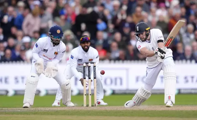 England's Gus Atkinson, right, in action during day three of the First Test match between England and Sri Lanka at Emirates Old Trafford, Manchester, England, Thursday Aug. 22, 2024. (Nick Potts/PA via AP)