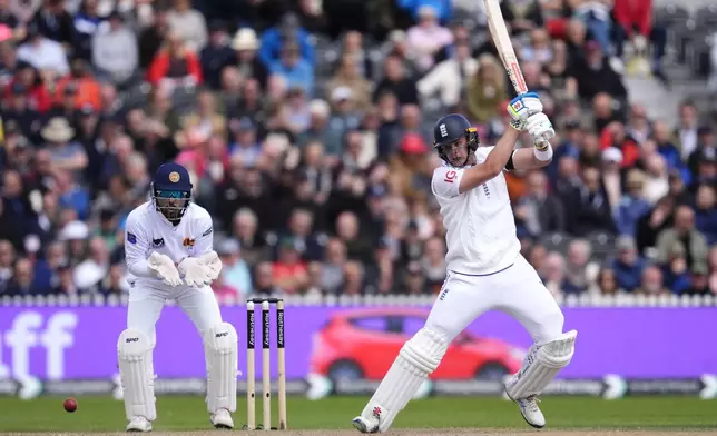 England's Jamie Smith, right, in action during day three of the First Test match between England and Sri Lanka at Emirates Old Trafford, Manchester, England, Thursday Aug. 22, 2024. (Nick Potts/PA via AP)