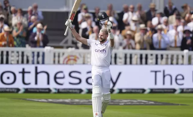 England's Gus Atkinson celebrates his century during during day two of the second Rothesay Men's Test cricket match between England and Sri Lanka at Lord's, London, Friday, Aug. 30, 2024. (John Walton/PA via AP)