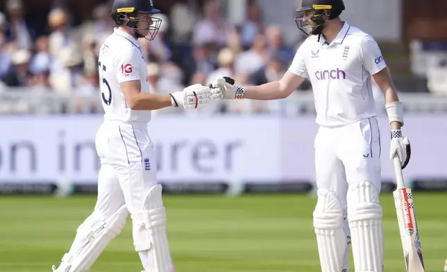 England's Gus Atkinson, right, and Matthew Potts prepare to bat during day two of the second Rothesay Men's Test cricket match between England and Sri Lanka at Lord's, London, Friday, Aug. 30, 2024. (John Walton/PA via AP)