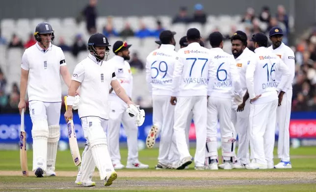 England's Ben Duckett, second left, leaves the pitch after LBW by Sri Lanka's Asitha Fernando on day two of the First Test match between England and Sri Lanka at Emirates Old Trafford, Manchester, England, Thursday Aug. 22, 2024. (Nick Potts/PA via AP)