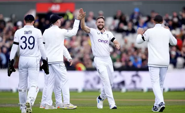 England's Chris Woakes, center, celebrates the wicket of Sri Lanka's Nishan Madushka on day three of the First Test match between England and Sri Lanka at Emirates Old Trafford, Manchester, England, Friday Aug. 23, 2024. (Nick Potts/PA via AP)