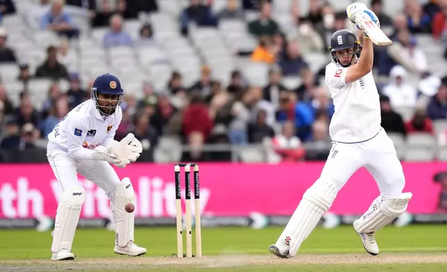 England's Jamie Smith, right, in action during day two of the First Test match between England and Sri Lanka at Emirates Old Trafford, Manchester, England, Thursday Aug. 22, 2024. (Nick Potts/PA via AP)