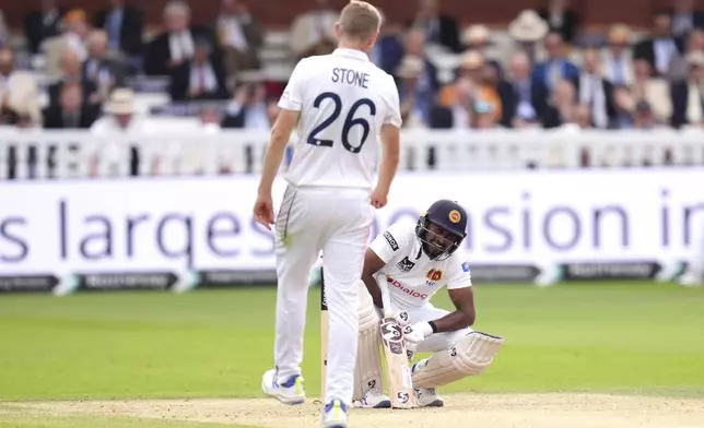 Sri Lanka's Kamindu Mendis reacts behind England's Olly Stone during day two of the second Rothesay Men's Test cricket match between England and Sri Lanka at Lord's, London, Friday, Aug. 30, 2024. (John Walton/PA via AP)