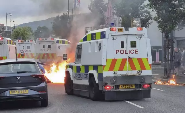 Police Service of Northern Ireland officers stand guard at a roadblock in Belfast, Northern Ireland, following an anti-Islamic protest outside Belfast City Hall on Saturday, Aug. 3, 2024. (David Young/PA via AP)