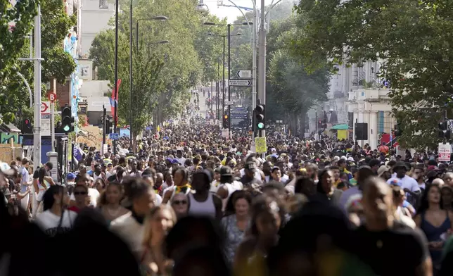 Crowds on Ladbroke Grove, London, during the Notting Hill Carnival celebration in west London, Monday, Aug. 26, 2024. (Lucy North/PA via AP)