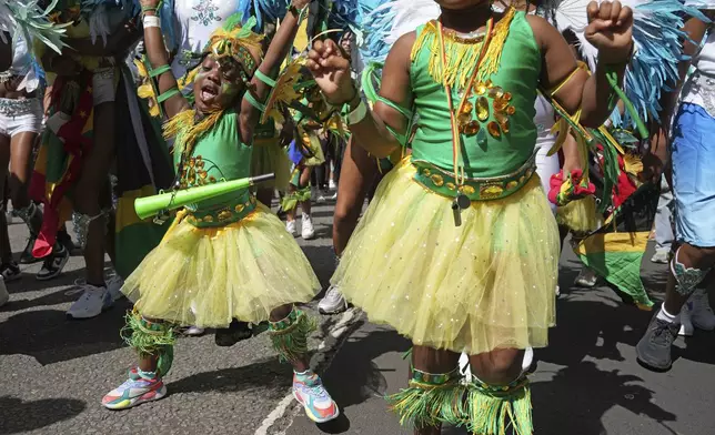 Participants take part in the Children's Day Parade, part of the Notting Hill Carnival celebration in west London, Sunday Aug. 25, 2024. (Jeff Moore/PA via AP)